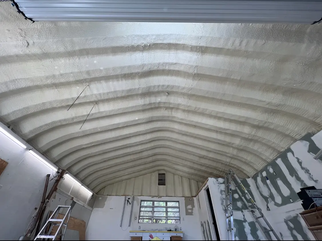 Spray polyurethane foam applied to the underside of a metal roof deck in North Logan